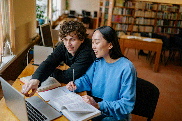 Students are researching topics for their dissertations in a library in the UK.